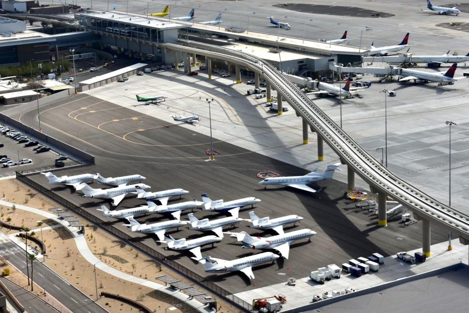 The PHX Sky Train track and jets parked at Phoenix Sky Harbor International Airport.