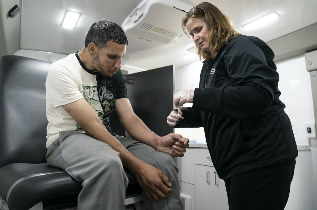 A registered nurse treats Dominic Rodriguez for a skin injury related to xylazine use in Philadelphia in May 2023. Treatment vans are allowed in the city, but not supervised injection sites. <a href="https://newsroom.ap.org/detail/Drug%20Overdoses%20Animal%20Drug/9c80e074d4e7453380be9404d3bcdd2c?Query=Philadelphia%20drugs&mediaType=photo&sortBy=creationdatetime:desc&dateRange=Anytime&totalCount=592&currentItemNo=21" rel="nofollow noopener" target="_blank" data-ylk="slk:Matt Rourke/AP Photo;elm:context_link;itc:0;sec:content-canvas" class="link ">Matt Rourke/AP Photo</a>