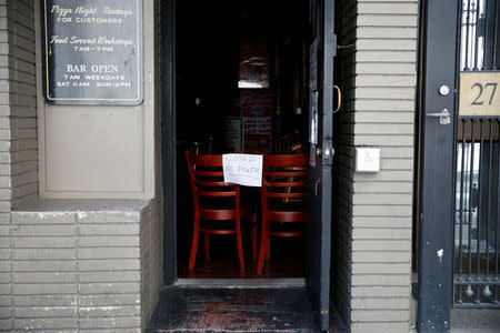 A closure sign is seen at a bar during a major power outage in the Financial District in San Francisco, California, U.S., April 21, 2017. REUTERS/Stephen Lam