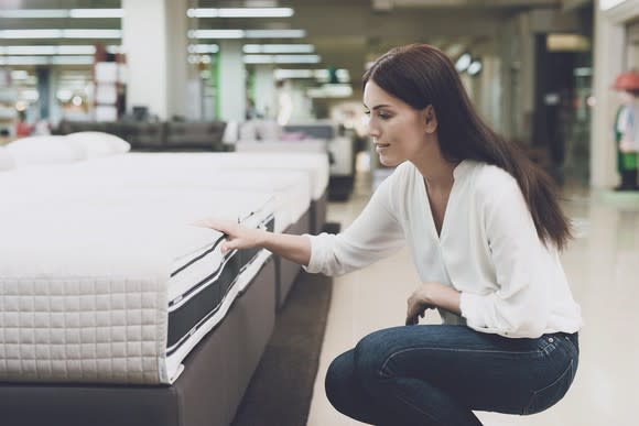 Woman shopping for a mattress.