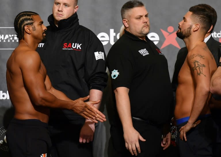 British boxers David Haye (L) and Tony Bellew (R) face each other during the weigh-in in east London on March 3, 2017 ahead of their heavyweight boxing bout