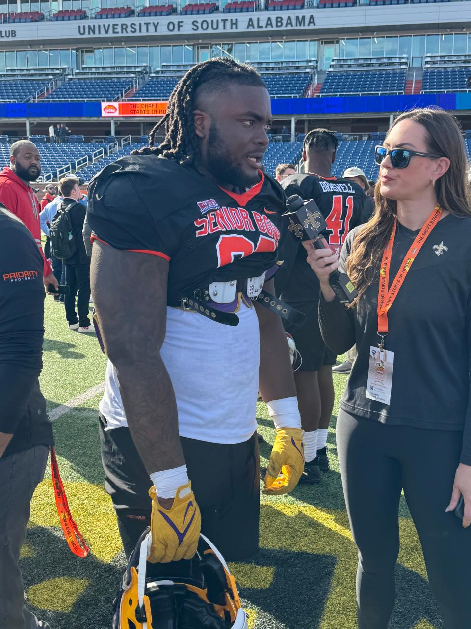 Navarre football alum Jordan Jefferson (left) talks with reporters on Tuesday, Jan. 30, 2024, after the first practice of the week at the 2024 Reese's Senior Bowl at Hancock Whitney Stadium in Mobile, Alabama.