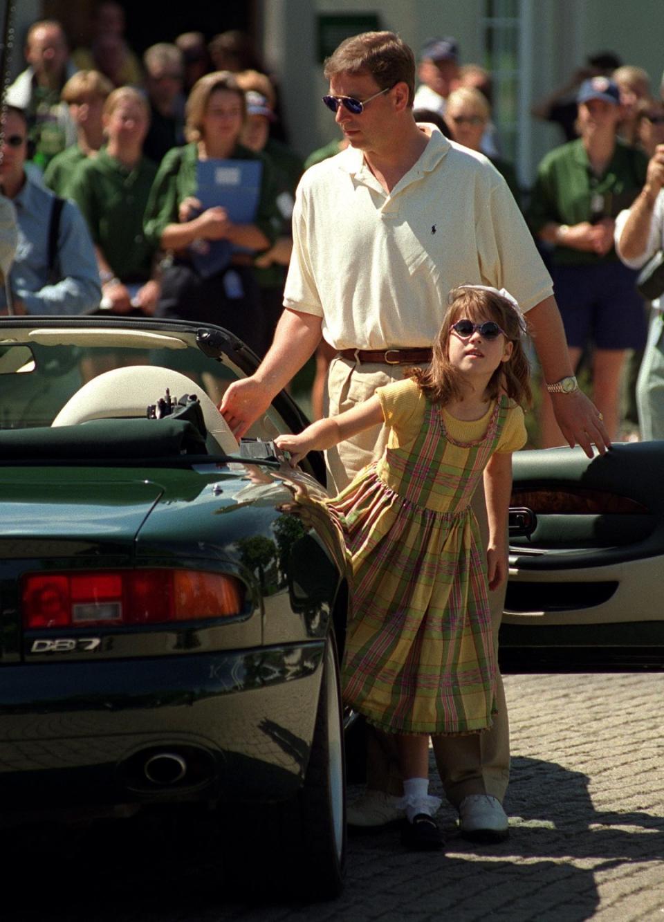 Princess Eugenie stepping out of Prince Andrew's Aston Martin