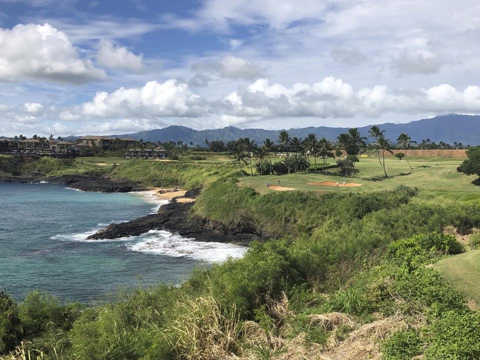 In this Nov. 15, 2018 photo, the 14th hole at the Hokuala Ocean Course in Lihue, Hawaii cuts across the Pacific Ocean on the east side of Kauai. The Ocean Course starts in mango and guava forests on the back nine before the 13th hole kicks off the longest stretch of continuous oceanfront holes on the Hawaiian islands. (AP Photo/John Marshall)