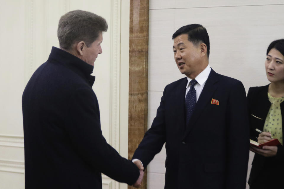 Ji Kyong Su, right, North Korea's vice minister of External Economic Relations, shakes hands with Oleg Kozhemyako, Russia's governor of the Maritime Territory Administration, after Kozhemyako arrived at the Pyongyang International airport in Pyongyang, North Korea, Monday, Dec. 11, 2023. (AP Photo/Cha Song Ho)