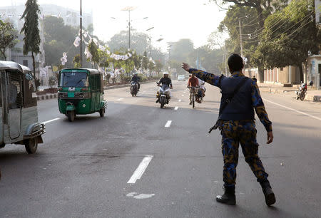 A policeman gestures to stop motorbikes for security check ahead of the 11th general election in Dhaka, Bangladesh, December 28, 2018. REUTERS/Mohammad Ponir Hossain