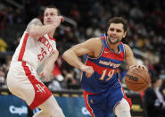 Washington Wizards' Raul Neto (19) moves the ball past Houston Rockets' Garrison Mathews during the first half of an NBA basketball game Wednesday, Jan. 5, 2022, in Washington. (AP Photo/Luis M. Alvarez)