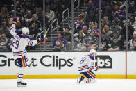 Edmonton Oilers left wing Zach Hyman (18) celebrates with center Leon Draisaitl (29) after scoring during overtime of Game 4 of an NHL hockey Stanley Cup first-round playoff series hockey game against the Los Angeles Kings Sunday, April 23, 2023, in Los Angeles. The Oilers won 5-4. (AP Photo/Ashley Landis)