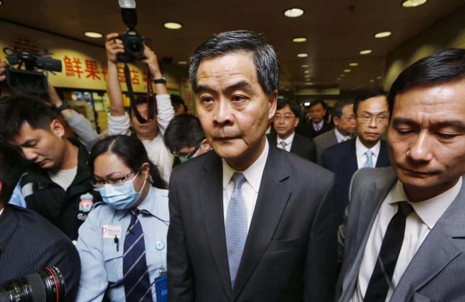 Hong Kong Chief Executive Leung Chun-ying leaves the hospital after visiting former Ming Pao chief editor Kevin Lau at a hospital in Hong Kong Wednesday, Feb. 26, 2014. The former editor of the Hong Kong newspaper whose abrupt dismissal in January sparked protests over press freedom has been stabbed, police said on Wednesday. Police said a man wearing a motorcycle helmet “suddenly” attacked Kevin Lau on Wednesday morning with a knife and then fled on a motorcycle driven by another man. (AP Photo/Kin Cheung)