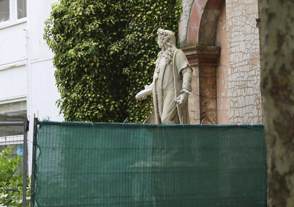 Fencing is put up around a statue of Robert Clayton at the St. Thomas Hospital in, London, Friday, June 12, 2020, following Black Lives Matter protests that took place across the UK over the weekend. The protests were ignited by the death of George Floyd, who died after he was restrained by Minneapolis police on May 25. (Aaron Chown/PA via AP)