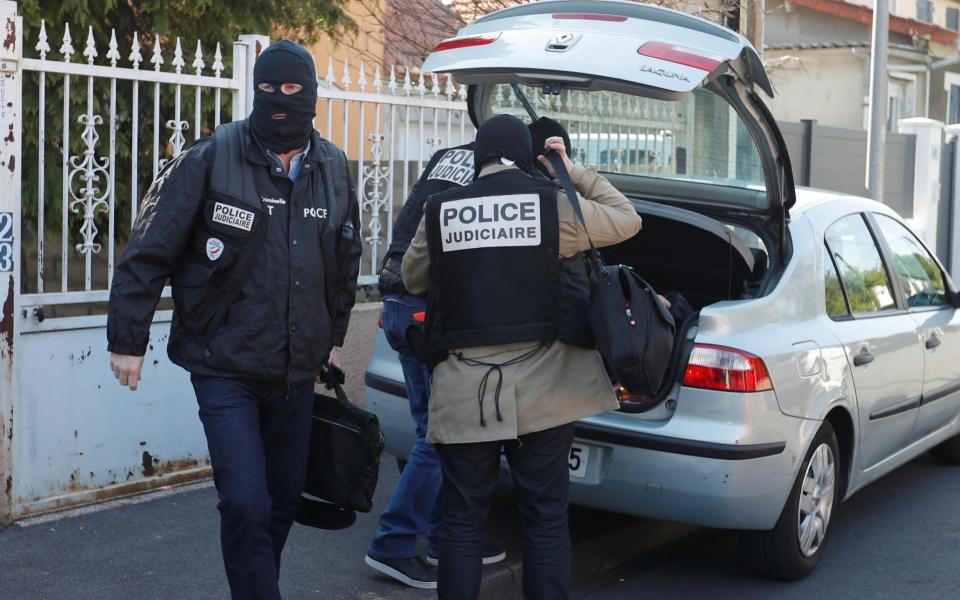 French police leave the house of the gunman killed in a shootout with police on the Champs Elysees Avenue, in the Paris suburb of Chelles - Credit: REUTERS/Charles Platiau