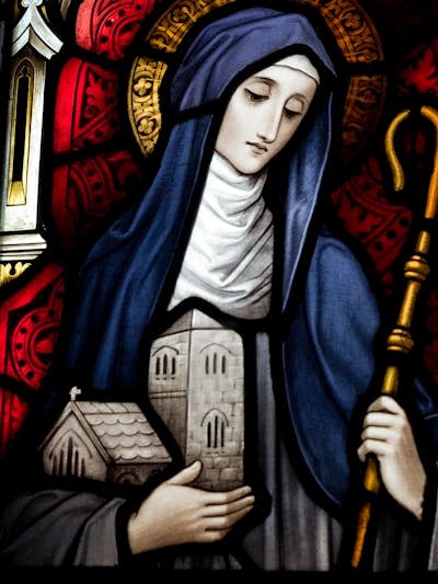 A stained-glass image of Saint Brigid.