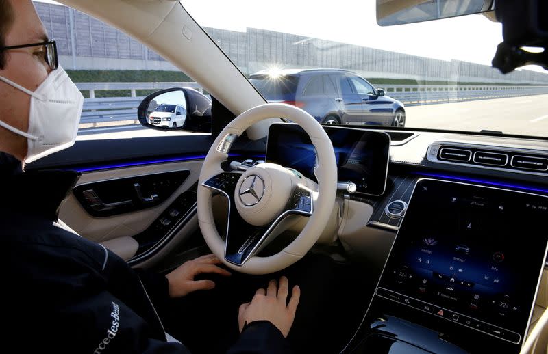 FILE PHOTO: An employee demonstrates steering by autonomous driving system in a new Mercedes-Benz S-Class limousine near Immendingen