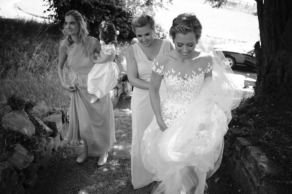 Excited nerves! My bridesmaid Victoria is helping me gather the layers of tulle of my dress and veil so I can get up the steps to the church.