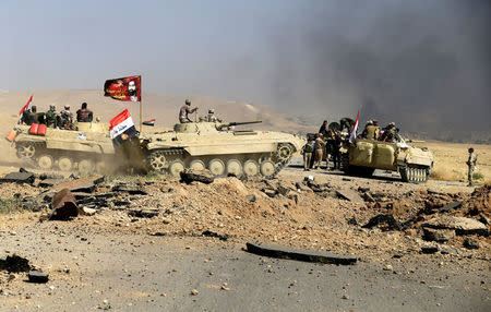 Members of Iraqi Army are seen during the war between Iraqi army and Shi'ite Popular Mobilization Forces (PMF) against the Islamic State militants in al-'Ayadiya, northwest of Tal Afar, Iraq August 28, 2017. REUTERS/Thaier Al-Sudani