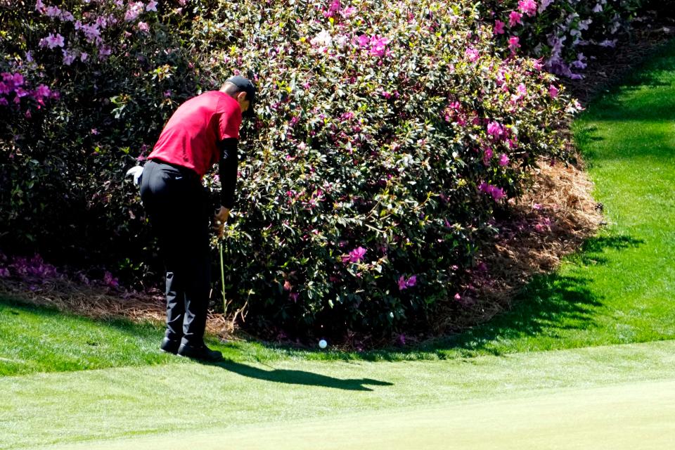 Tiger Woods hits a chip shot left-handed on the 13th green during Sunday's final round of the Masters.