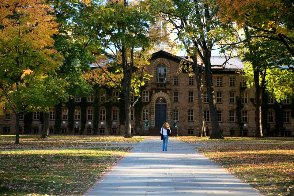 A student walks toward Princeton University's Nassau Hall. The college plans to begin "virtual instruction" starting March 23. (Photo: Terryfic3D via Getty Images)