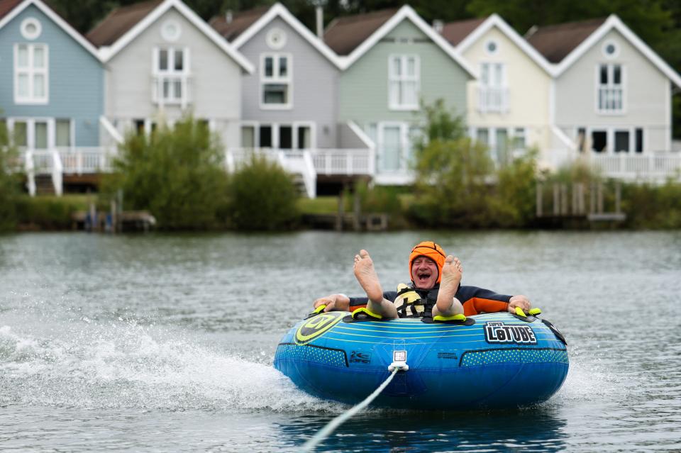 Ed Davey rides an inflatable while campaigning (REUTERS)