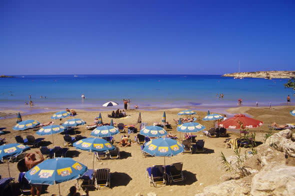 Sunbathers on Coral bay beach, Pafos, South Cyprus