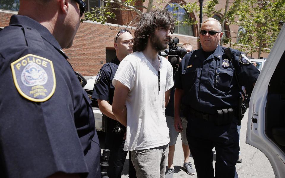 Police in Boston detain an unidentified man after removing a cleaver from his car. (Michael Dwyer/AP)