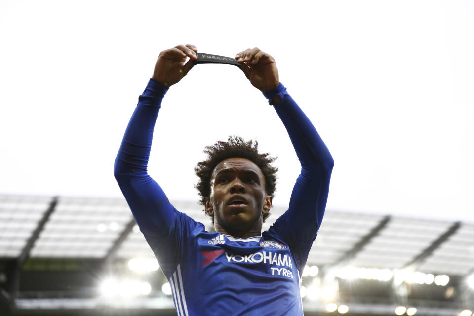 Britain Football Soccer - Manchester City v Chelsea - Premier League - Etihad Stadium - 3/12/16 Chelsea's Willian celebrates scoring their second goal and holds a armband in respect for the victims of the Colombia plane crash containing the Chapecoense players and staff Action Images via Reuters / Jason Cairnduff Livepic EDITORIAL USE ONLY. No use with unauthorized audio, video, data, fixture lists, club/league logos or "live" services. Online in-match use limited to 45 images, no video emulation. No use in betting, games or single club/league/player publications. Please contact your account representative for further details.