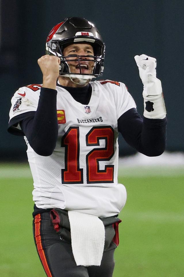 New England Patriots quarterback Tom Brady (12) gives a hug to