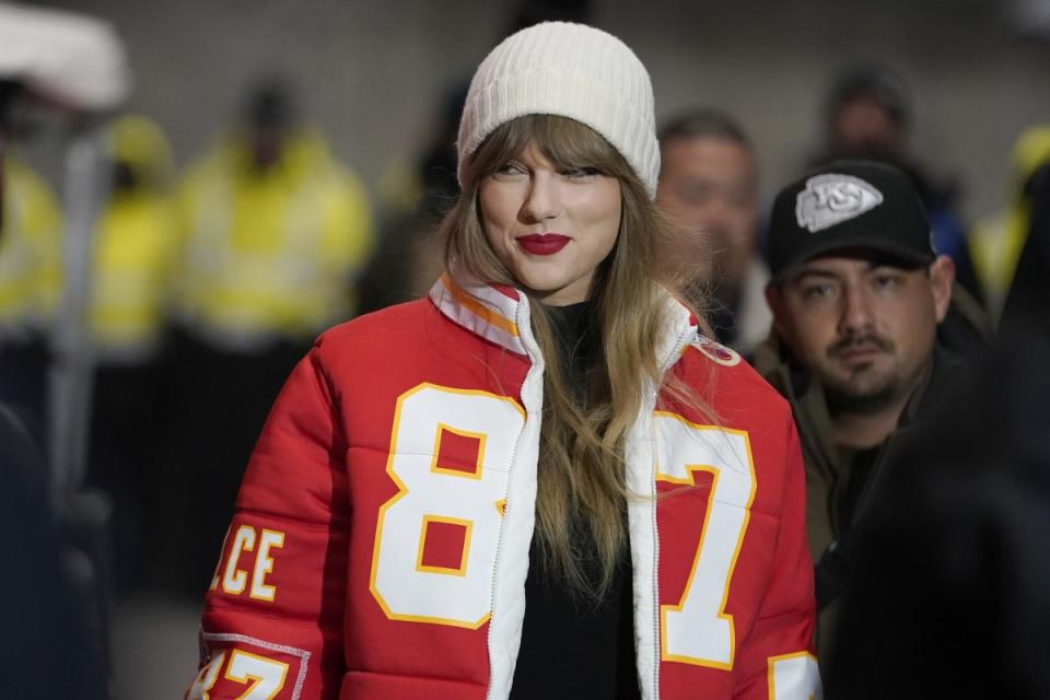 Taylor Swift wears a Kansas City Chiefs tight end Travis Kelce puffer jacket, designed by Kristin Juszczyk, as she arrives before an NFL wild-card playoff football game between the Chiefs and the Miami Dolphins, Saturday, Jan. 13, 2024, in Kansas City, Mo. (AP Photo/Ed Zurga, File)