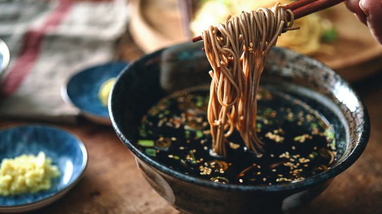 Noodles in a bowl of dark soy sauce