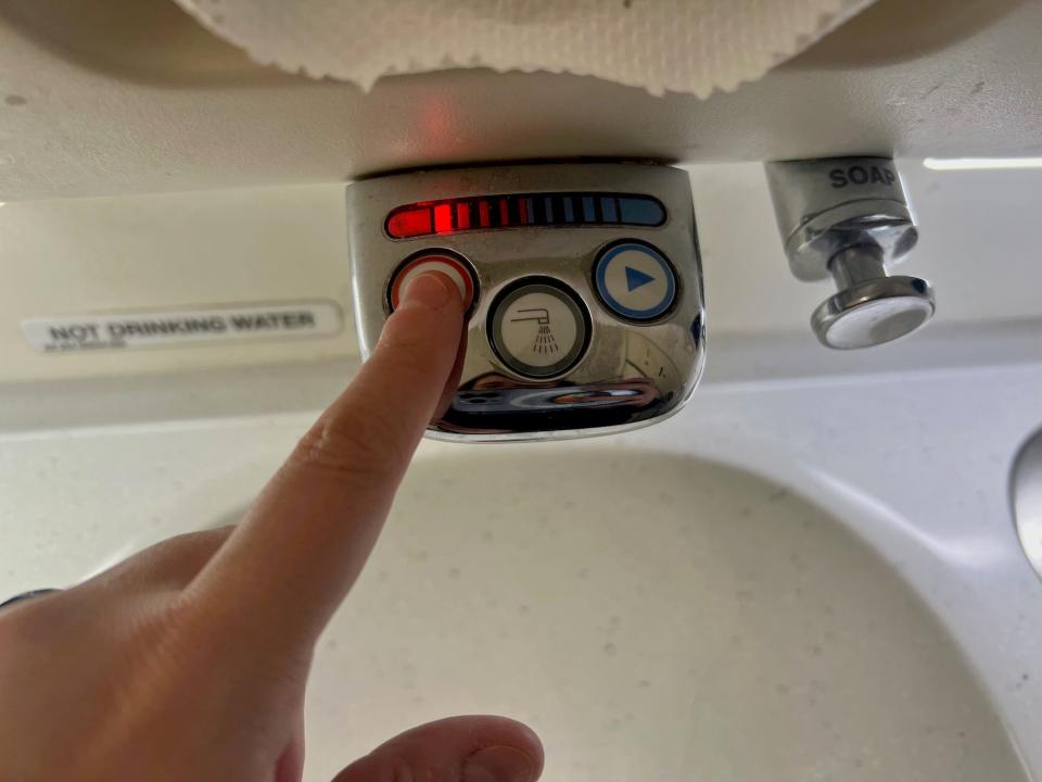 The author adjusting the sink water temperature in Singapore's A380 lavatory.