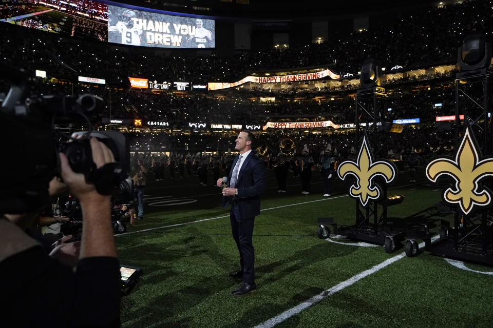 Former New Orleans Saints quarterback Drew Brees acknowledges the crowd as he is honored during a ceremony at halftime of an NFL football game between the New Orleans Saints and the Buffalo Bills in New Orleans, Thursday, Nov. 25, 2021. (AP Photo/Derick Hingle)