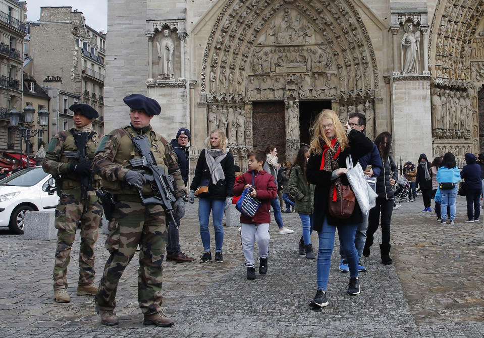 In this Tuesday, Oct. 30, 2018, photo soldiers patrol at the Notre Dame cathedral in Paris, France. Synagogues, mosques, churches and other houses of worship are routinely at risk of attack in many parts of the world. And so worshippers themselves often feel the need for visible, tangible protection even as they seek the divine. (AP Photo/Michel Euler)