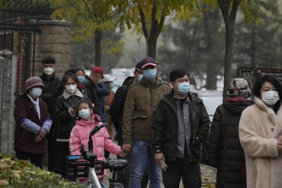 Residents line up for COVID tests in Beijing, Thursday, Nov. 24, 2022. China is expanding lockdowns, including in a central city where factory workers clashed this week with police, as its number of COVID-19 cases hit a daily record. (AP Photo/Ng Han Guan)