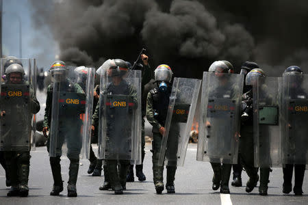 Riot police take position as demonstrators rally against Venezuela's President Nicolas Maduro's government in Caracas, Venezuela April 10, 2017. REUTERS/Carlos Garcia Rawlins