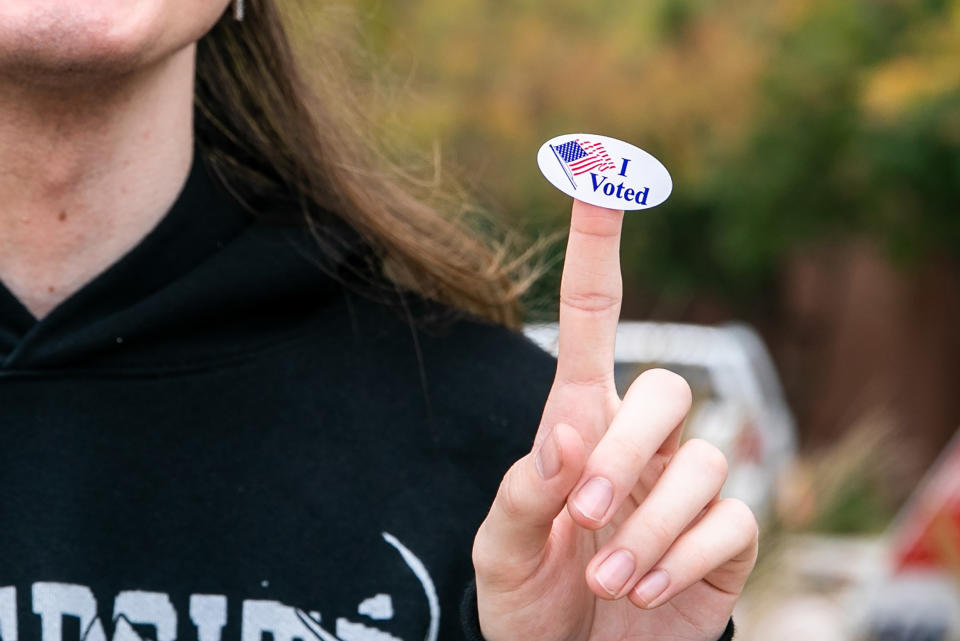 Person showing off an "I Voted" sticker on their index finger