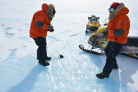 Belgo-Japanese SAMBA meteorite team members photographing a meteorite found during a field trip on the Nansen Ice Field, 140km south of Princess Elisabeth Antarctica, during the BELARE 2012-2013 expedition. (Photo courtesy of International Polar Foundation) <br> <br> <a href="http://www.livescience.com/27550-big-meteorite-found-antarctica.html" rel="nofollow noopener" target="_blank" data-ylk="slk:Click here to see the full collection at LiveScience.com;elm:context_link;itc:0;sec:content-canvas" class="link ">Click here to see the full collection at LiveScience.com</a>