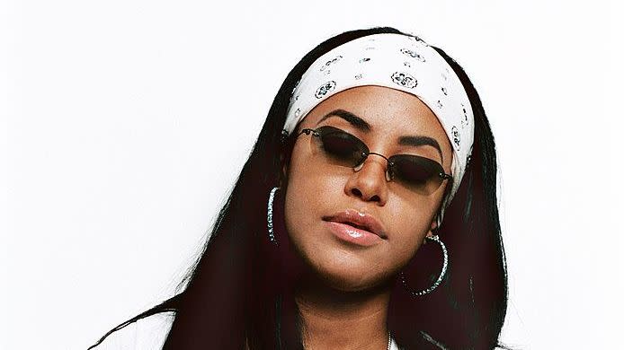 best 90s fashion trends, woman, aaliyah, wearing a white bandana and black shades