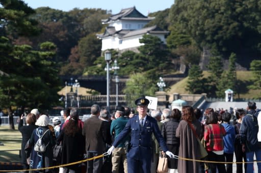 Police officers stand guard around Japan's Imperial Palace ahead of Sunday's parade