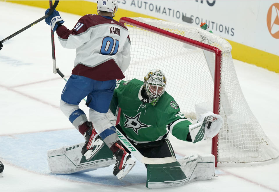 Dallas Stars goaltender Jake Oettinger (29) makes a save with his glove in front of Colorado Avalanche center Nazem Kadri (91) during the third period of an NHL hockey game in Dallas, Friday, Nov. 26, 2021. The Stars won 3-1. (AP Photo/LM Otero)