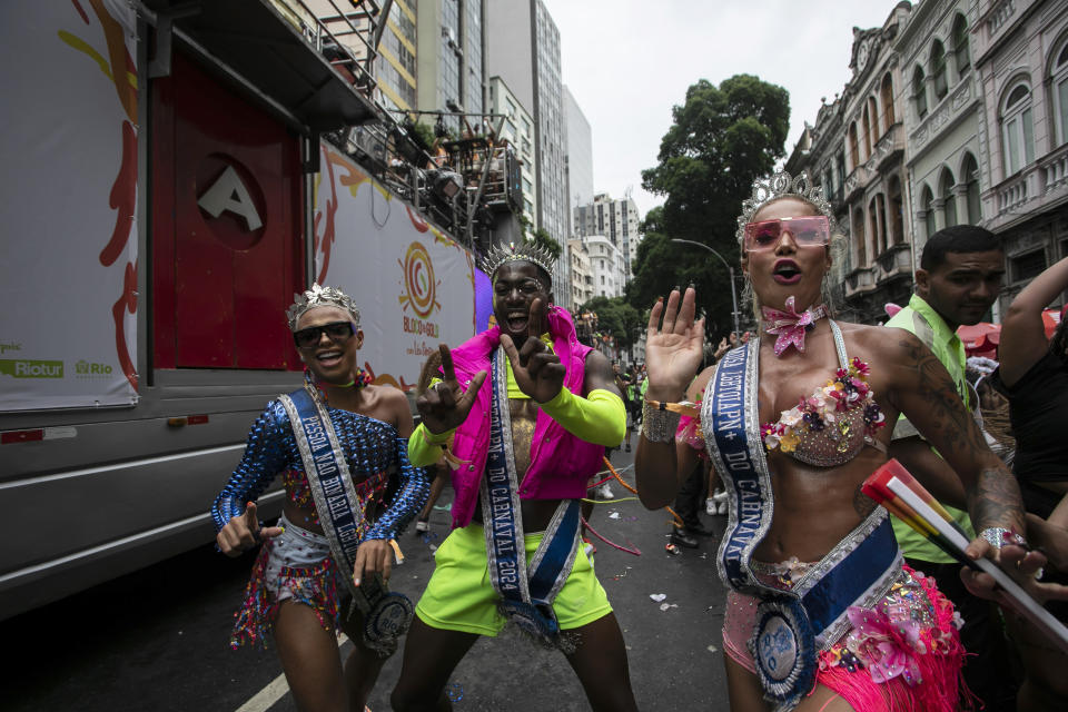 Revelers dance alongside a sound truck known as an electric trio, during a pre-carnival "Bloco da Gold" street party, in Rio de Janeiro, Brazil, Saturday, Jan. 27, 2024. A fixture of Brazil's Carnival festivities, the rigs effectively did away with front-row seats, making Carnival more accessible to the crowds of revelers. (AP Photo/Bruna Prado)