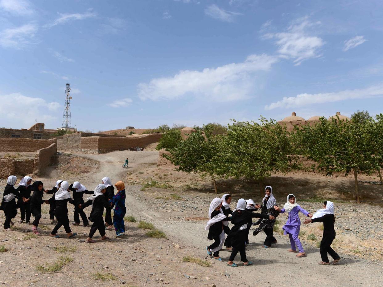 Afghan school girls play outside after classes at Guzara district of Herat, Afghanistan: Getty