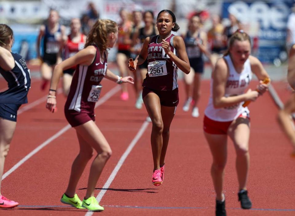 State College’s Chloe Poindexter, back, prepares to hand off the baton to Amy Devan, front, in the girls Class 3A 4x800 meter relay finals during the PIAA State Track and Field Championships held Saturday at Seth Grove Stadium on the Shippensburg University campus in Shippensburg.