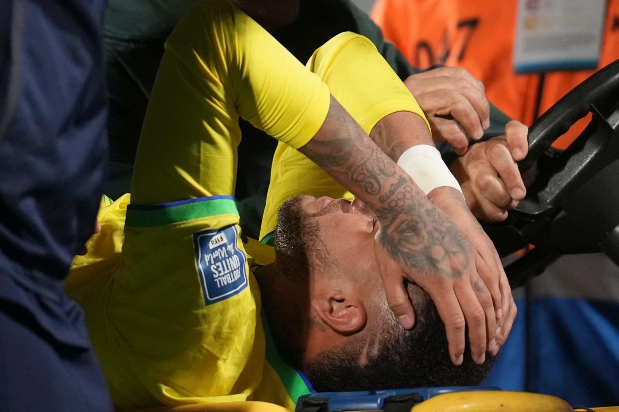 Neymar is carried off the pitch on a stretcher after being injured during Brazil's World Cup qualifying match against Uruguay.