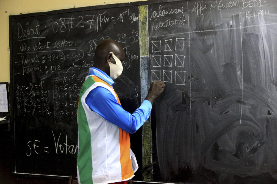 Electoral commission officials count the votes for the presidential election in Abidjan, Ivory Coast, Saturday, Oct. 31, 2020. Some tens of thousands of security forces have been deployed across the Ivory Coast on Saturday as the leading opposition parties boycotted the election, calling President Ouattara's bid for a third term illegal. (AP Photo/Diomande Ble Blonde)