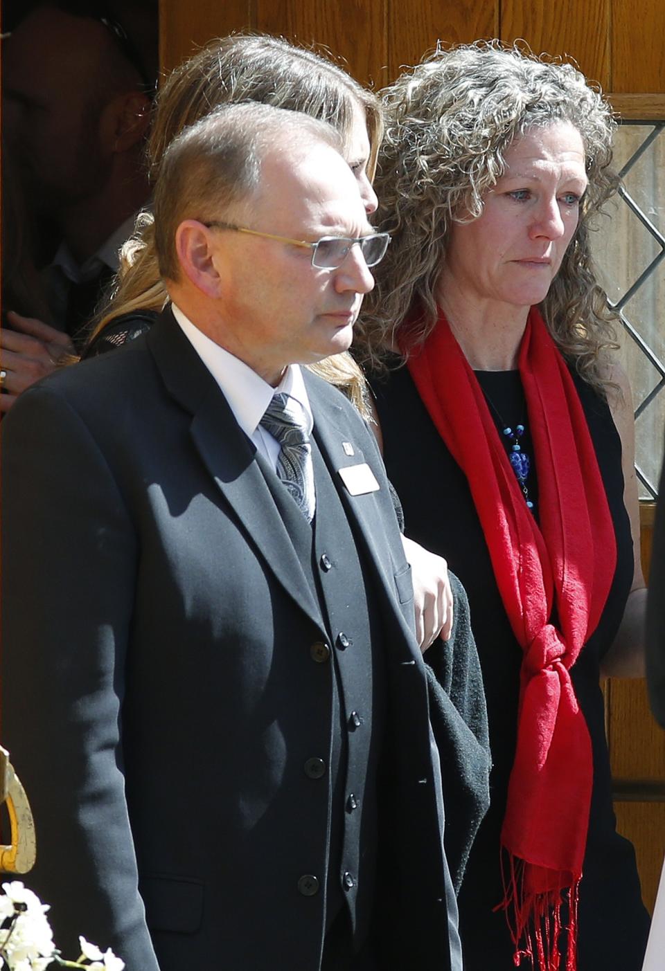 Kelly Hunter (R) leaves the funeral of her son Josh Hunter in Calgary, Alberta, April 21, 2014. Matthew de Grood is charged with killing Hunter and four of his friends at a house party in Calgary's worst mass murder in the history of the city, according to local media reports. REUTERS/Todd Korol (CANADA - Tags: CRIME LAW OBITUARY)