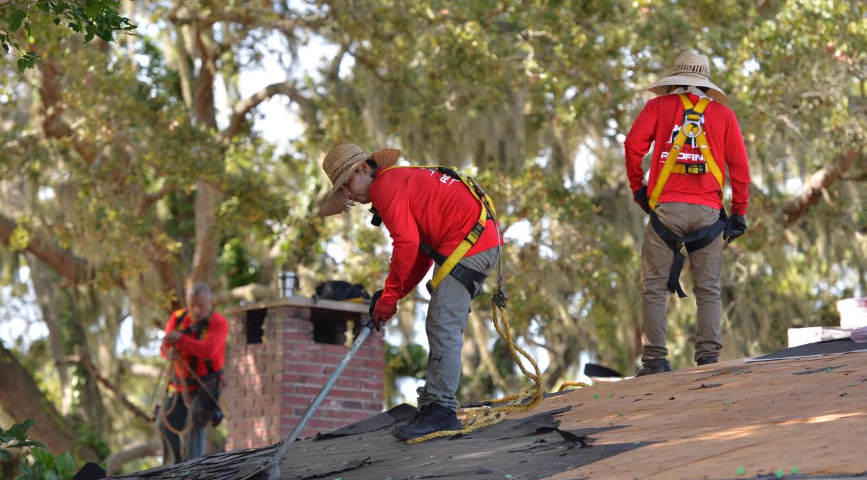 Roofers from Mighty Dog Roofing remove old shingles and tar paper from a home in South Venice on Tuesday, July 26, 2022. Air Force veteran Richard Eaton is receiving a new roof as part of the Owens Corning Roof Deployment Project. Mighty Dog Roofing Southwest Florida, an Owens Corning platinum roofing contractor, is working on the project. Eaton was selected through partnership with Purple Heart Homes. 
