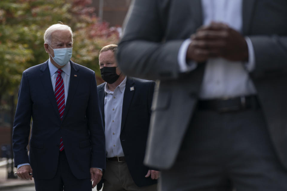 Democratic presidential candidate former Vice President Joe Biden walks to his motorcade vehicle after talking with Wilmington, Del., police officers as he departs The Queen theatre in Wilmington, Del., Monday, Oct. 19, 2020. (AP Photo/Carolyn Kaster)