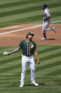 Houston Astros' Jason Castro, top, rounds the bases after hitting a two-run home run off Oakland Athletics pitcher Sean Manaea, bottom, during the second inning of a baseball game in Oakland, Calif., Sunday, April 4, 2021. (AP Photo/Jeff Chiu)