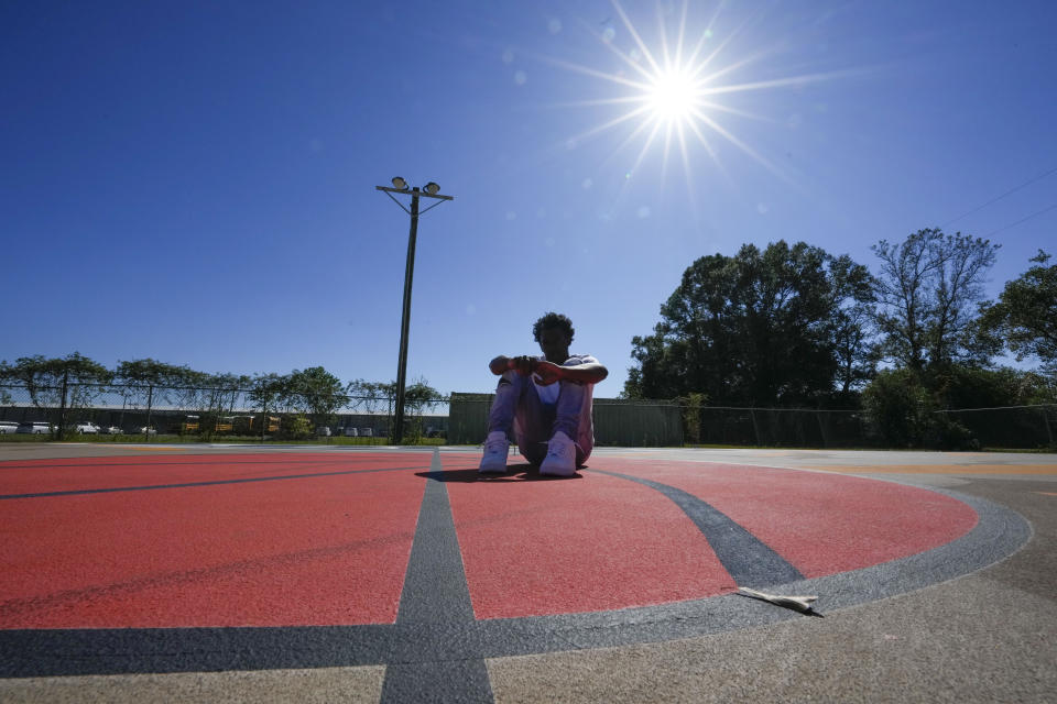 Bryant West poses for a portrait on a basketball court built by NBA star Devin Booker, who went to high school here, in Moss Point, Miss., Friday, Oct. 20, 2023. They attend the same classes with access to the same programs, and even come from the same families. But girls consistently are outperforming boys, graduating at higher rates at public high schools around the country. (AP Photo/Gerald Herbert)