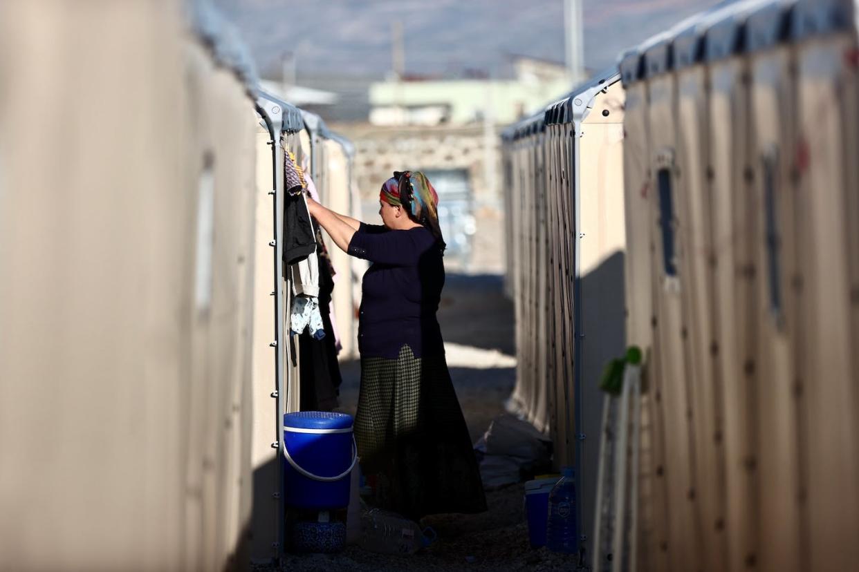 A woman does laundry at a tent city after the Feb. 6, 2023, earthquake in Turkey. <a href="https://media.gettyimages.com/id/1249051385/photo/debris-of-191-buildings-removed-so-far-after-the-quakes.jpg?s=1024x1024&w=gi&k=20&c=KUsB1AM3ksT9LLWCWgdB-d18pUrf3BjxerY9yHen-R0=A" rel="nofollow noopener" target="_blank" data-ylk="slk:Omer Urer/Anadolu Agency via Getty Images;elm:context_link;itc:0;sec:content-canvas" class="link ">Omer Urer/Anadolu Agency via Getty Images</a>