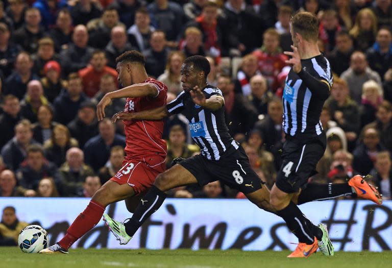 Liverpool's Jordon Ibe (L) fights for the ball with Newcastle United's Vurnon Anita during their English Premier League match, at Anfield in Liverpool, north-west England, on April 13, 2015